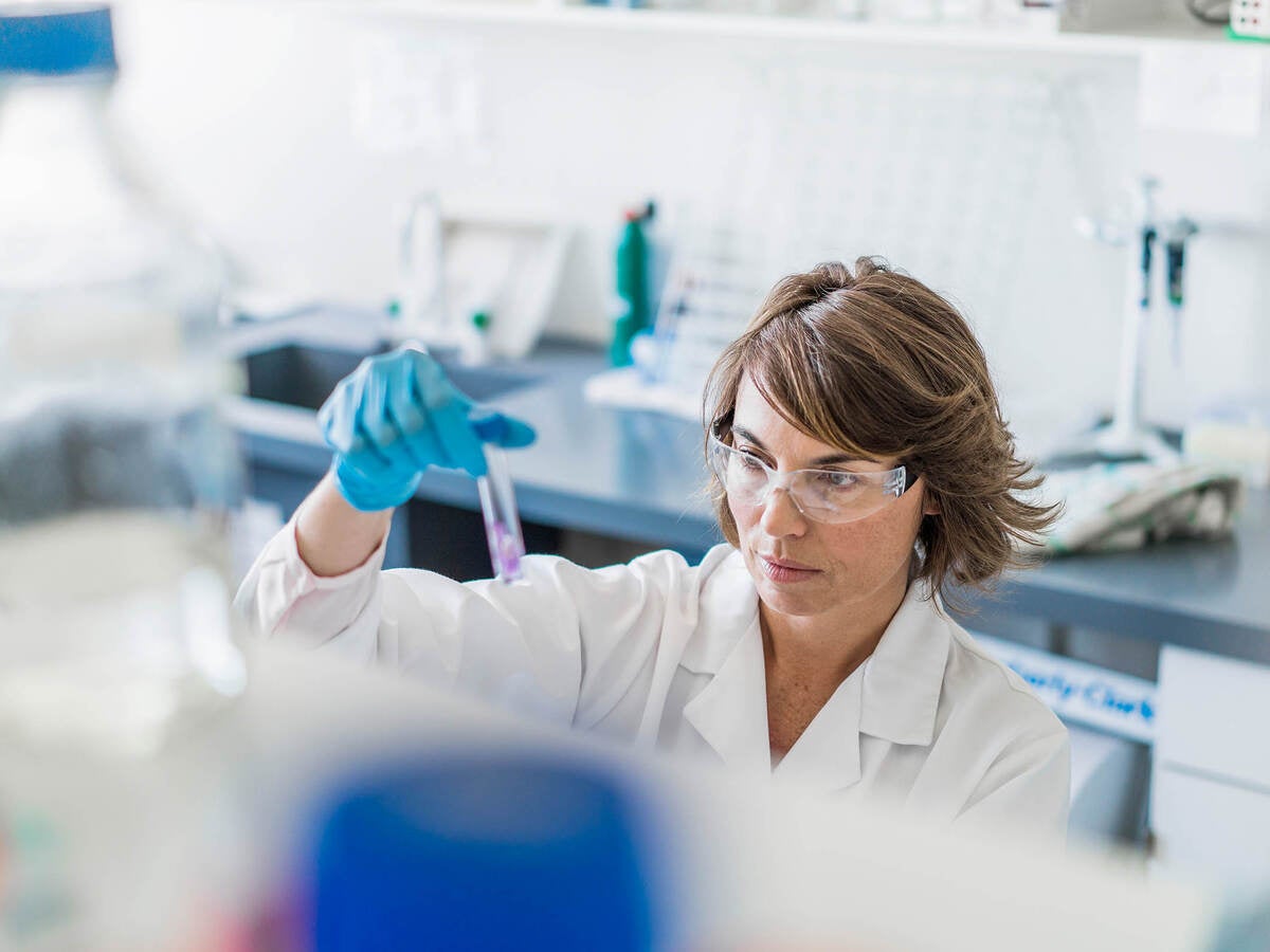 Scientist inspecting sample in a test tube